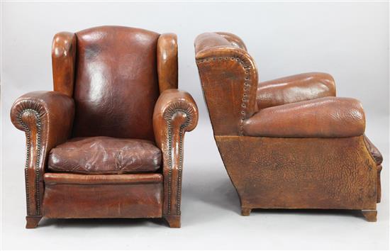 A pair of 1940s French tan leather club armchairs, W.2ft 11in. D.3ft H.2ft 10in.